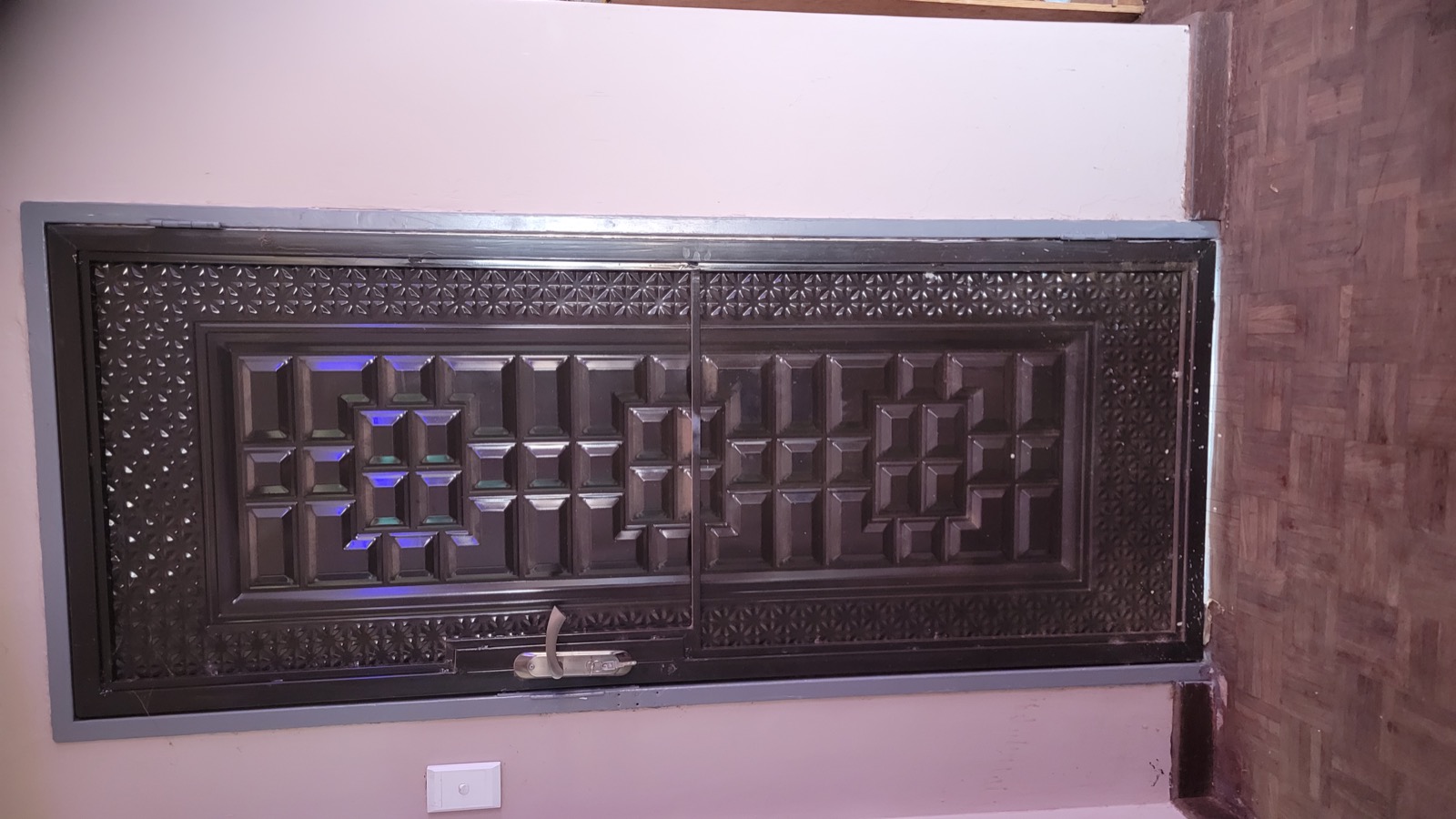 Decorative black security door with geometric raised panels