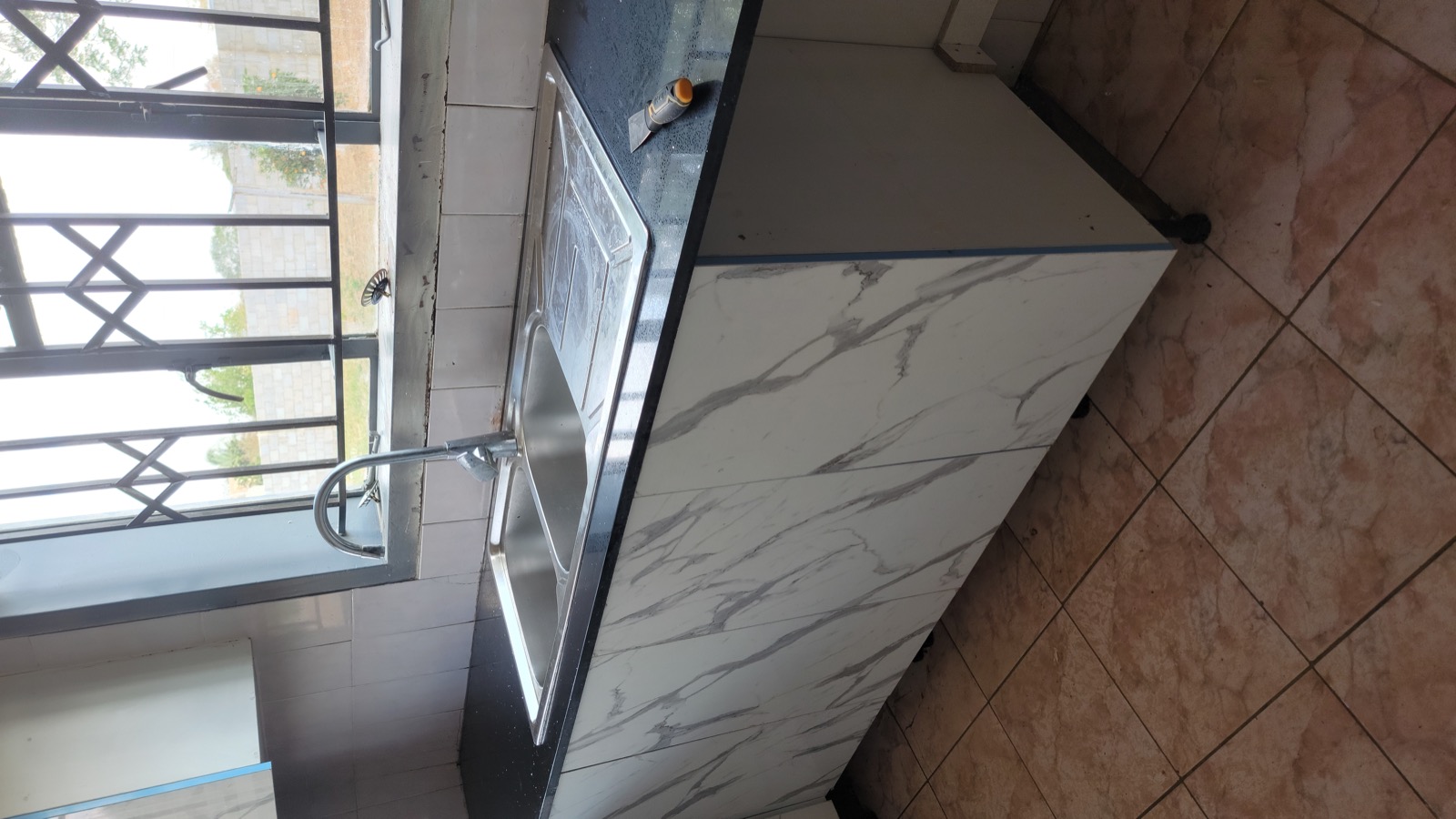 Newly installed kitchen sink and cabinetry