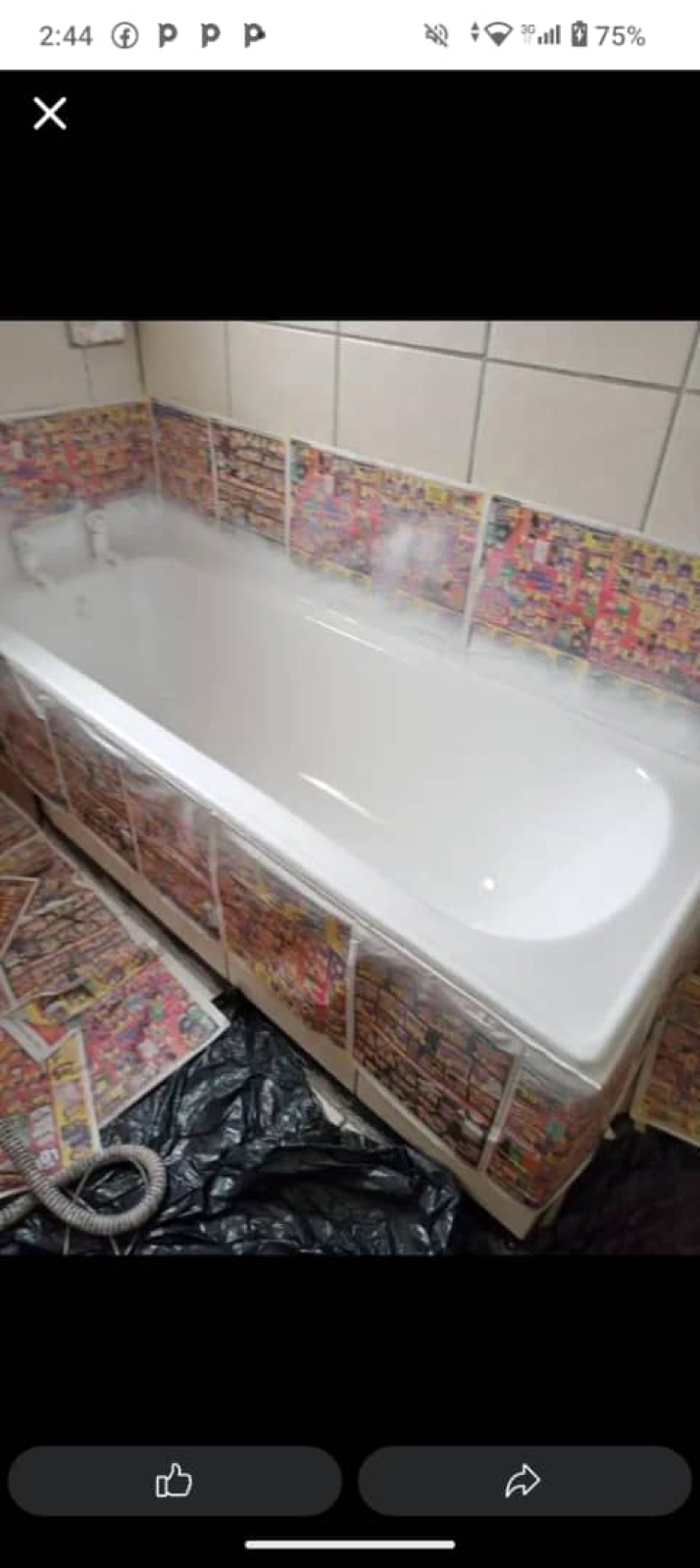 Newly fitted white bath in a tiled room