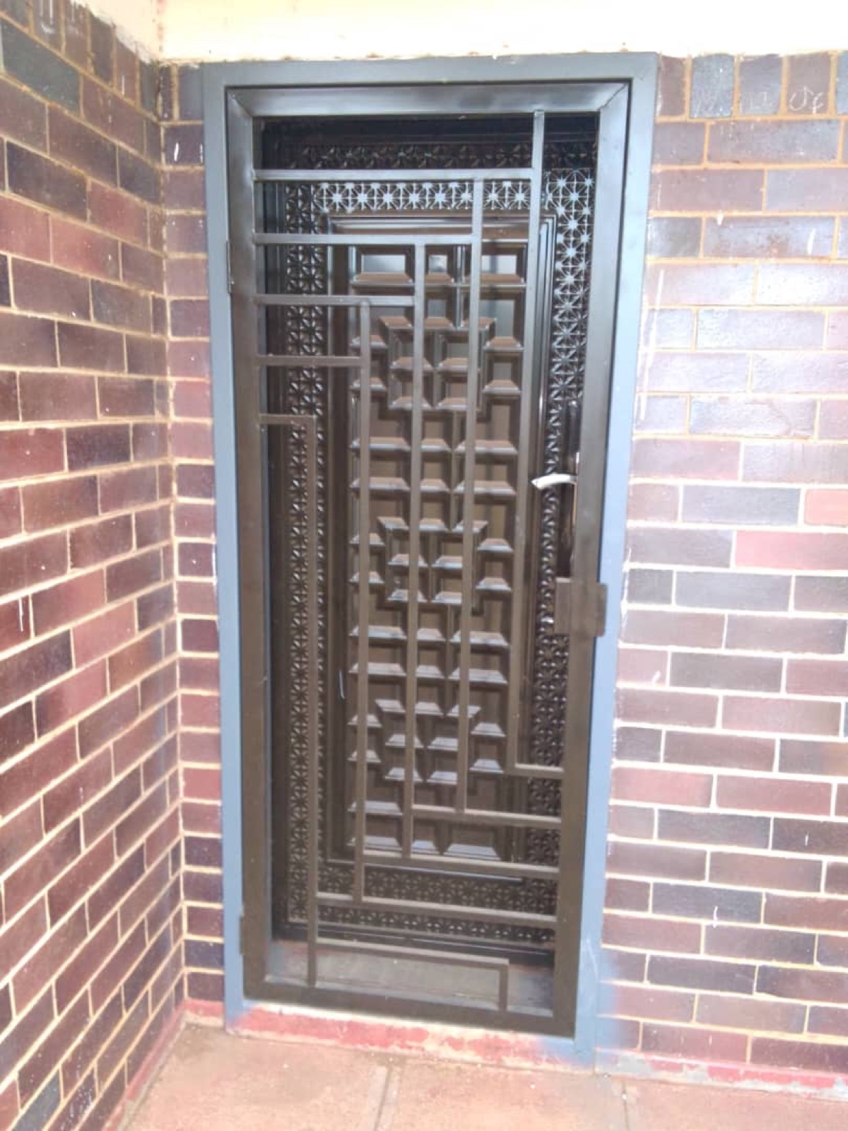 Decorative bronze security door at a home entrance